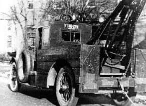 ( About Us ) Old photo of a tow truck